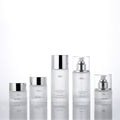 Ready-to-ship cosmetic glass bottle set packaging, including 30ml pump-style essential oil dispensing bottles and 30g glass jars for skincare creams and lotions
