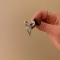 Small silver bow [about 1cm long]