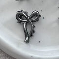 Gun black small bow [about 1cm long]